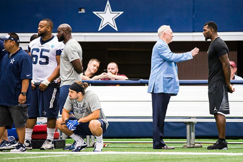 Cowboys owner Jerry Jones talks to receiver Dez Bryant, who dropped by the team's minicamp...