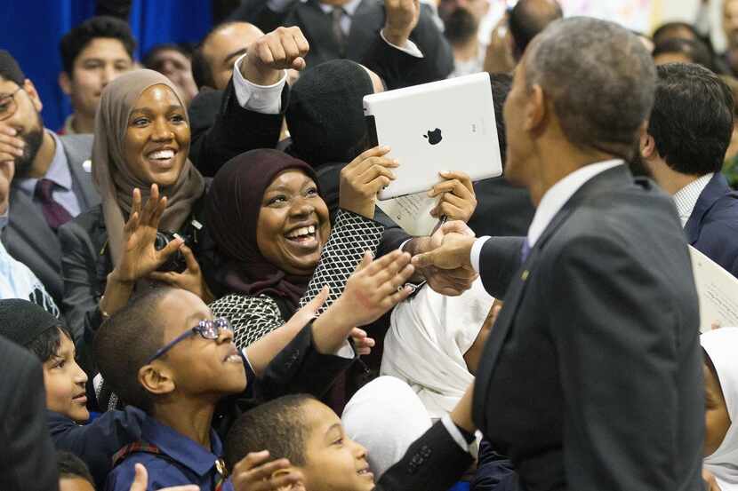 
President Barack Obama greets children from Al-Rahmah school and other guests during his...