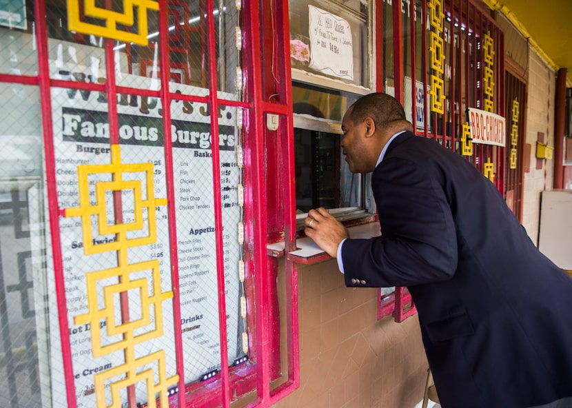 State Rep. and Dallas mayoral candidate Eric Johnson greets a worker at Wimpy's Famous...