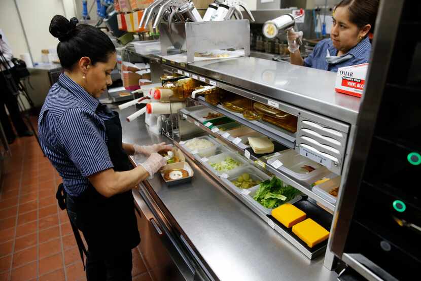 Silvia Ruiz prepares a specialty sandwich at a McDonald's restaurant in Chicago. (AP/Charles...