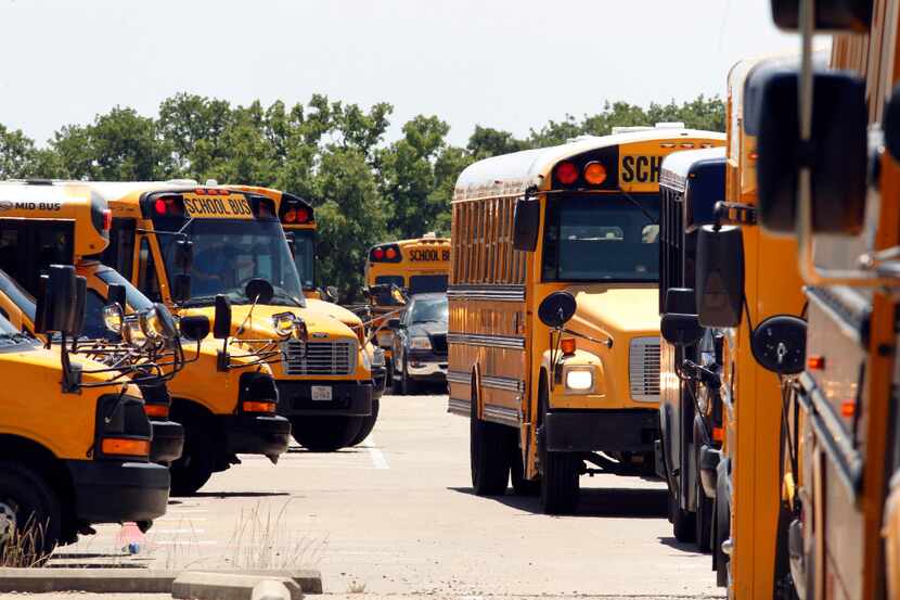 Dallas County Schools bus drivers leave Kleberg Service Center to pick up students in Dallas...