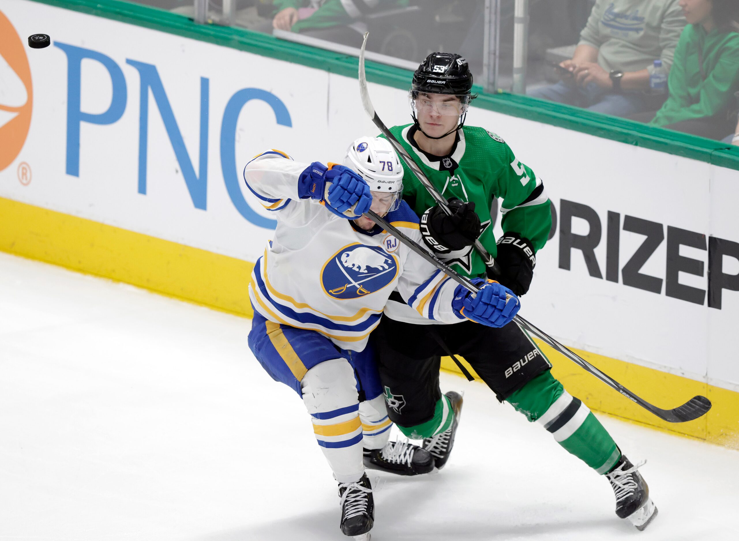 Dallas Stars center Wyatt Johnston (53) and Buffalo Sabres defenseman Jacob Bryson (78)...