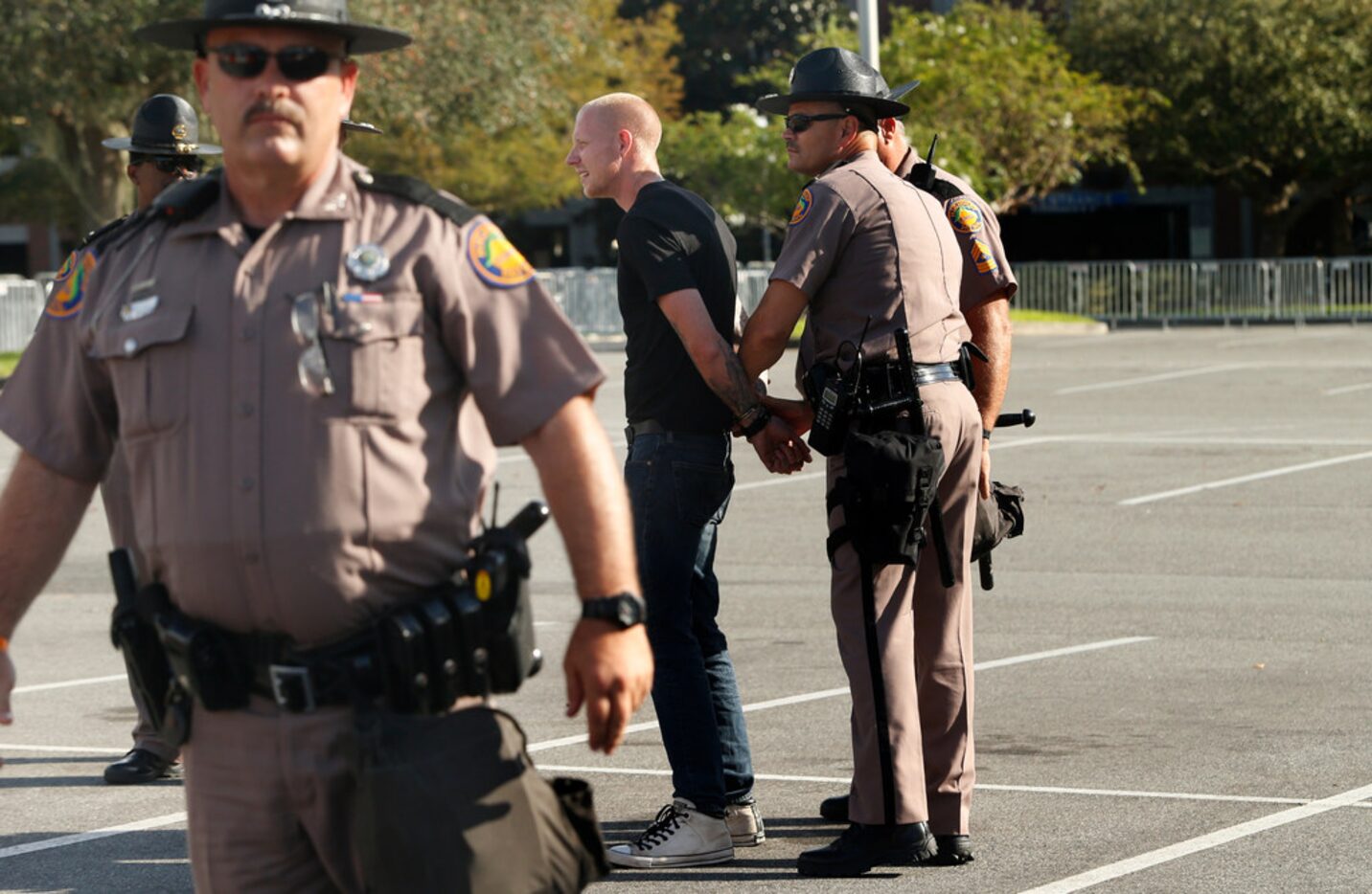 Self-described white nationalist Tyler Tenbrink, of Houston, Texas, is handcuffed by Florida...