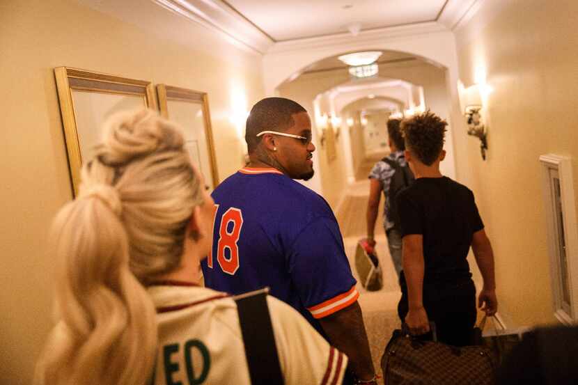 Prince Fielder returns to his hotel with wife Chanel Fielder and sons Jadyn, 12 (in black)...