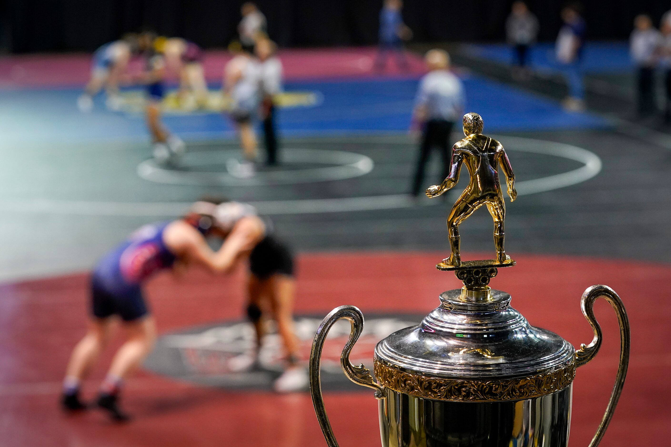 The championship trophy is seen as wrestlers compete during the NCWA national championships...