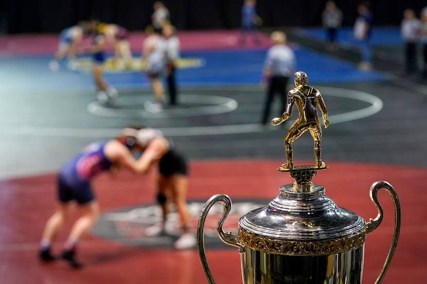 The championship trophy is seen as wrestlers compete during the NCWA  national championships...