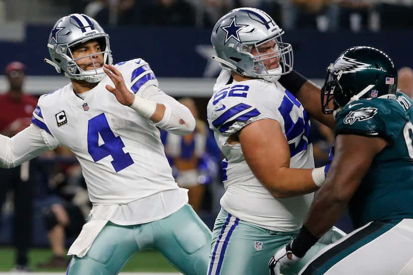Dallas Cowboys quarterback Dak Prescott (4) winds up to throw behind a block by Dallas...