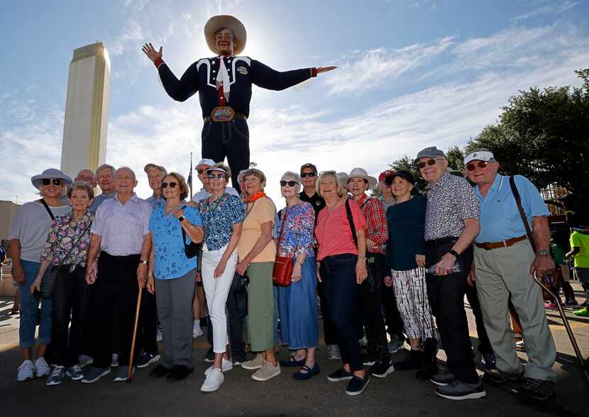 Vietnam veterans and their wives pose for a photo in front of Big Tex at the State Fair of...