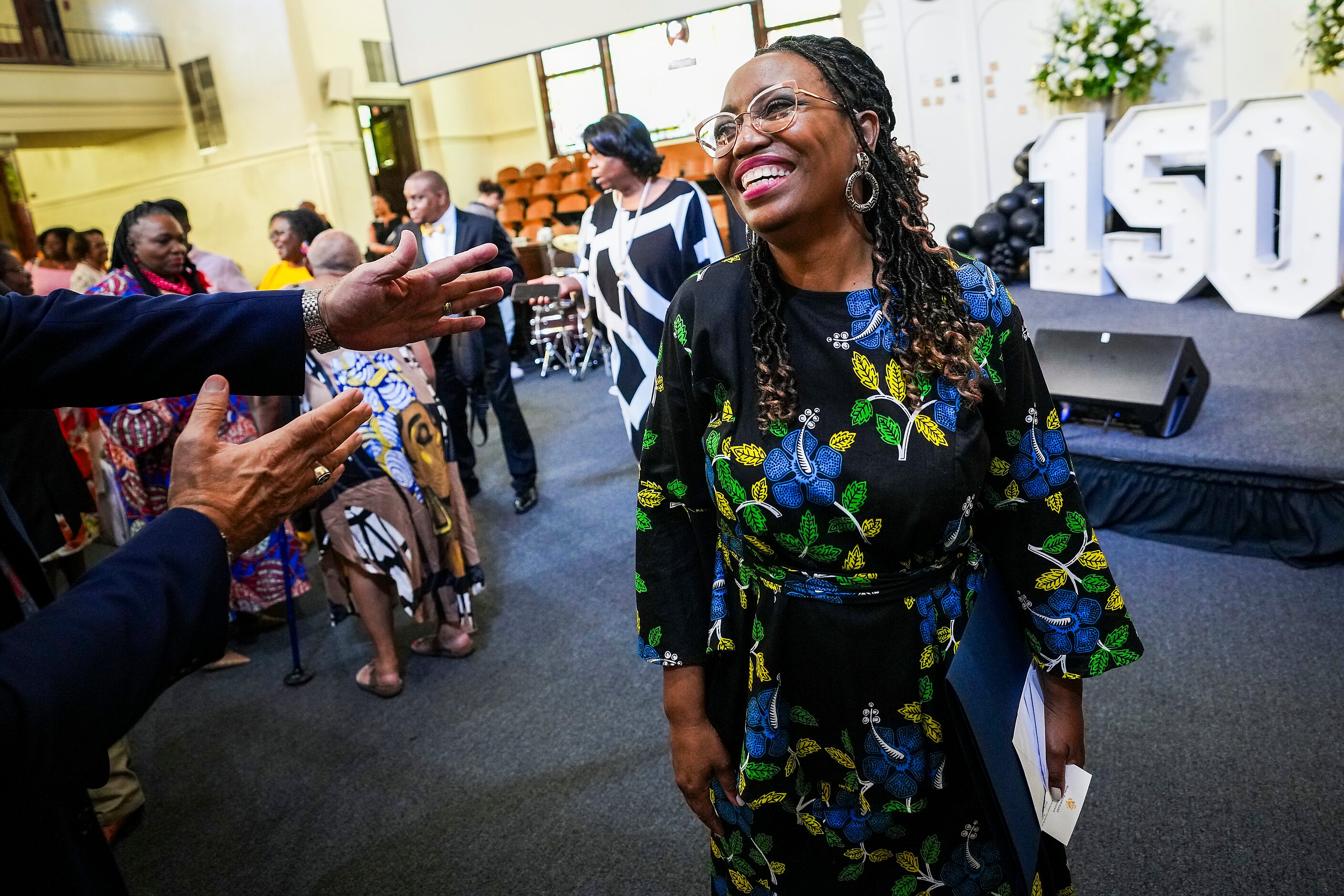 Senior pastor Lucretia Facen is congratulated by Reuben Saenz, Jr., Bishop of the the North...