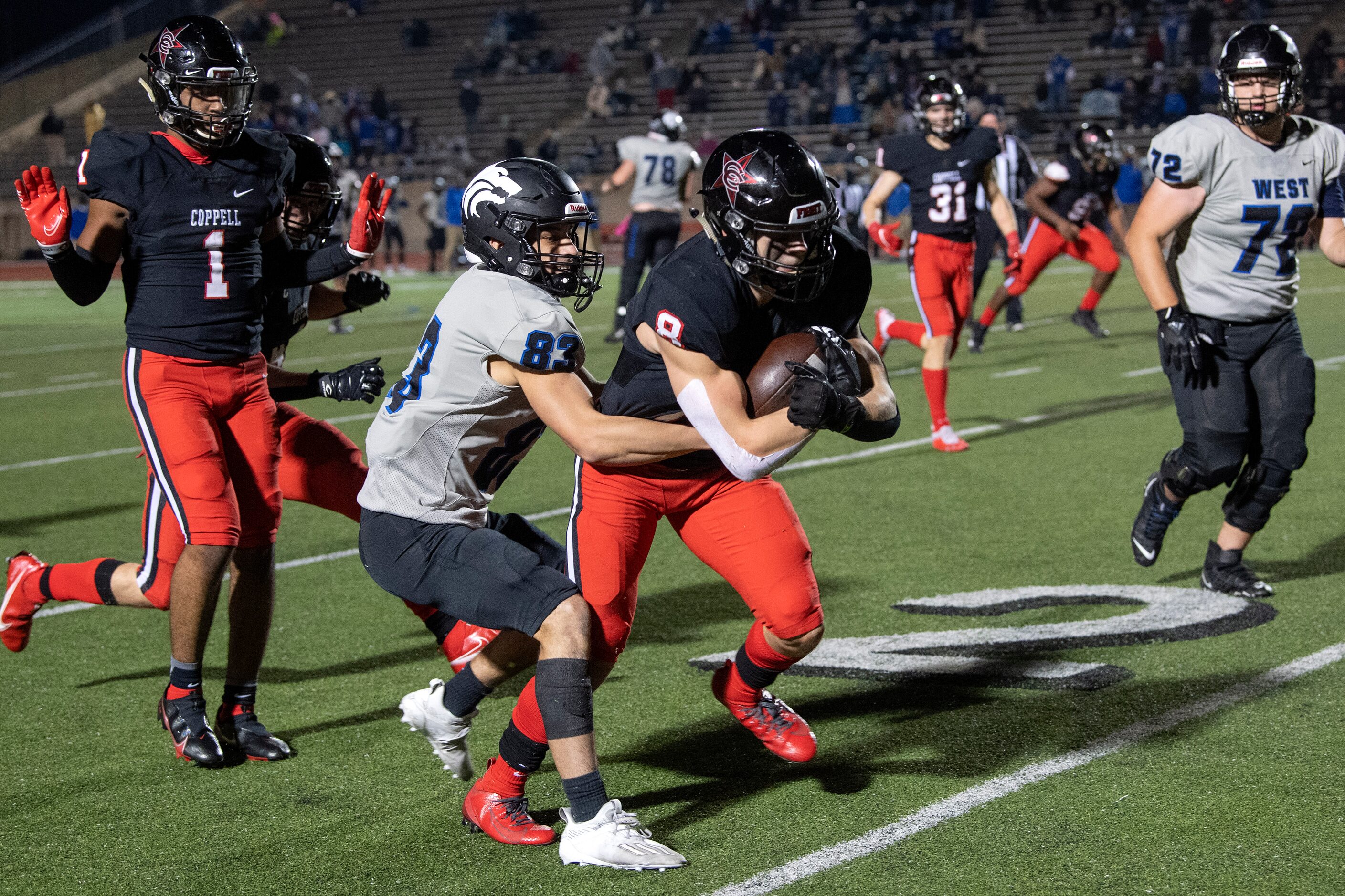 Coppell senior defensive back Cameron Peters (8) is tackled by Plano West senior wide...