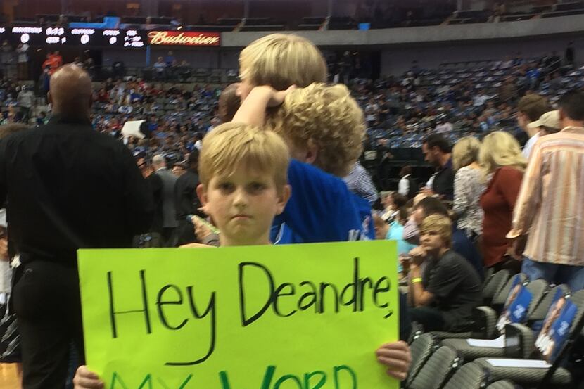 A fan poses with a sign before Wednesday's Mavericks game. (Scott Bell/Staff)