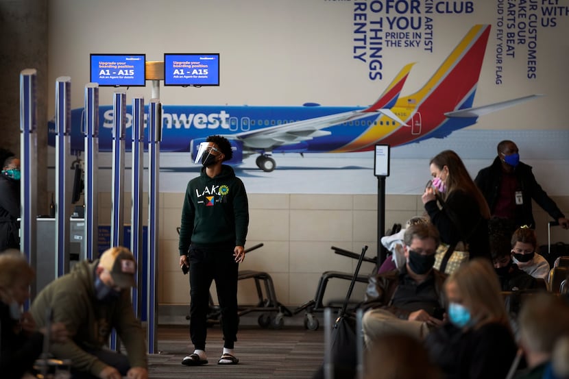 Passengers waited at Southwest Airlines gates inside the terminal at Dallas Love Field...