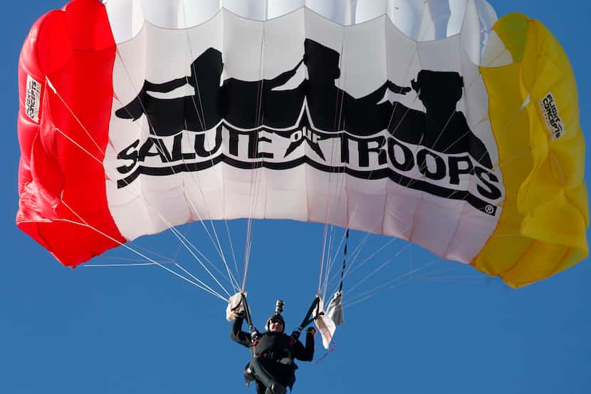 Skydivers celebrate the Bell Helicopter Armed Forces Bowl at Amon G. Carter Stadium in Fort...