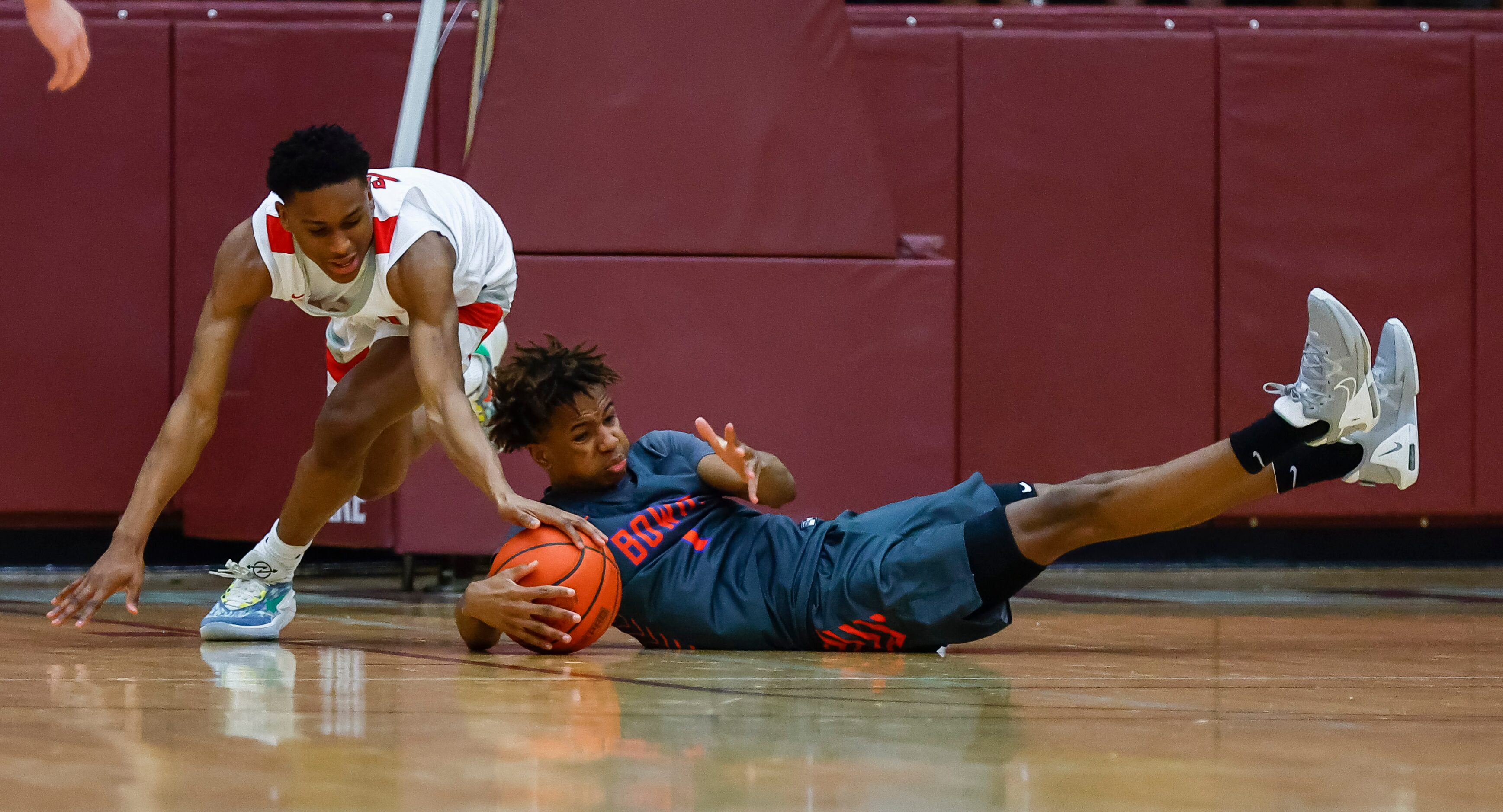 Lake Highlands senior guard Quinton Perkins, left, battles Arlington Bowie sophomore guard...