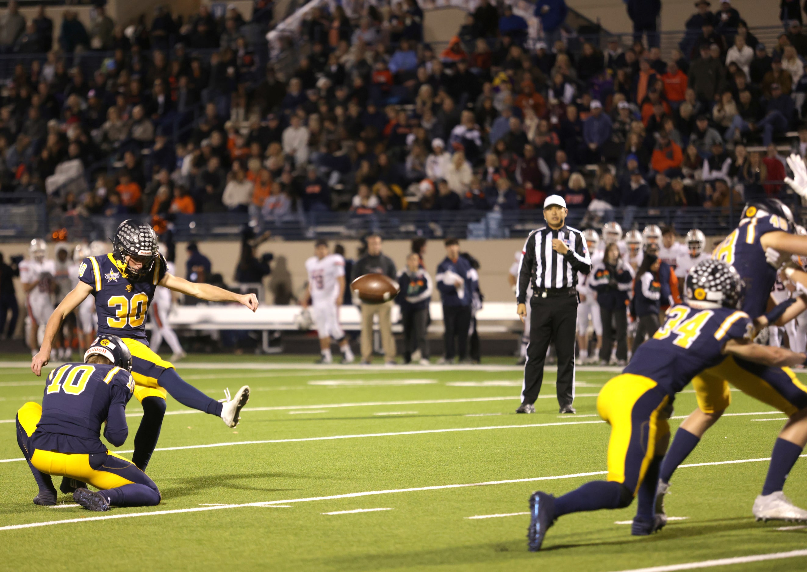 Highland Park's Reece Tiffany kicks a field goal in a football playoff game against Frisco...