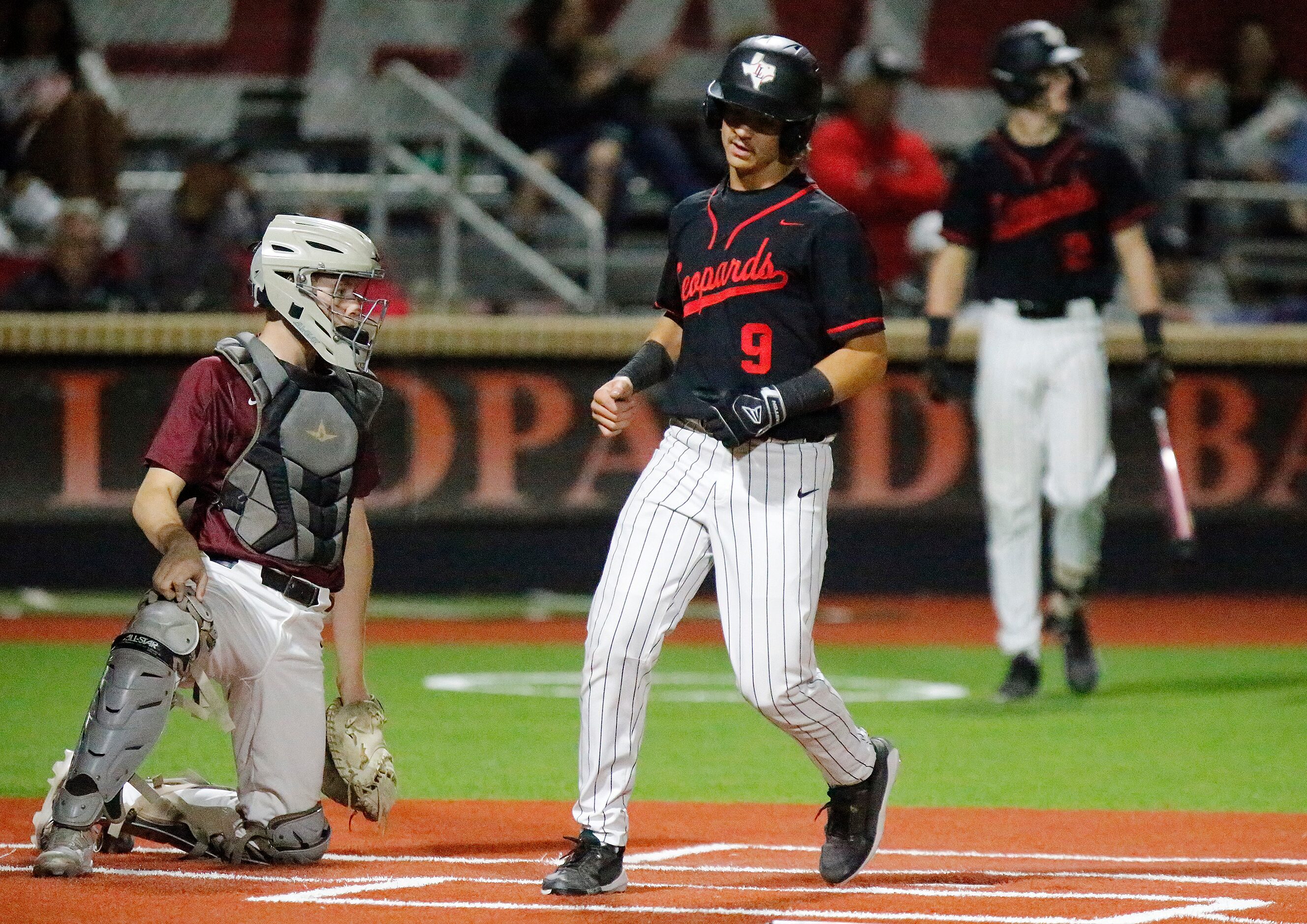 Lovejoy High School shortstop Kolby Branch (9) scores a run in the third inning as Lovejoy...