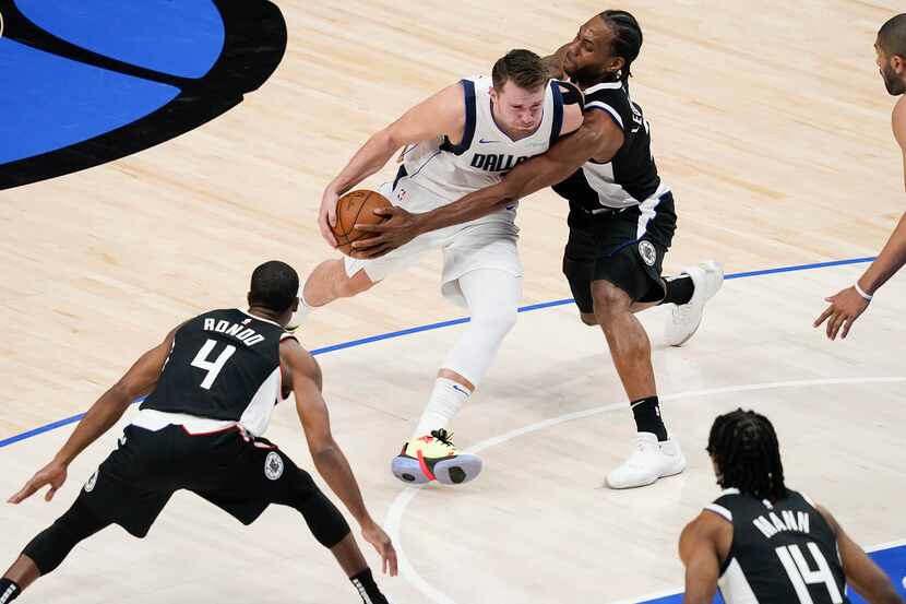 Dallas Mavericks guard Luka Doncic (77) has the ball knocked away by LA Clippers forward...