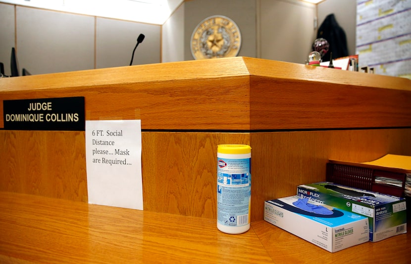 PPE and signs remind people to distance and wear a mask in Judge Dominique Collins' Criminal...