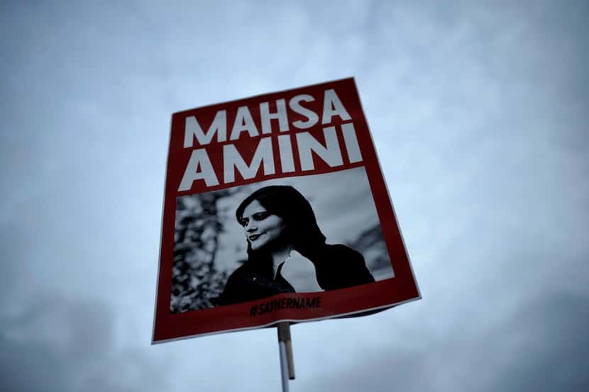 A woman in Berlin held a placard with a picture of Iranian woman Mahsa Amini during a...