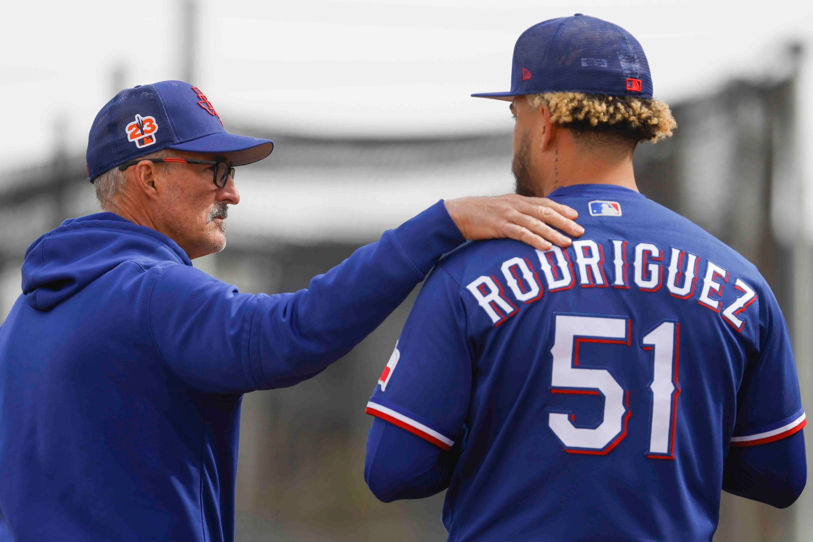 Texas Rangers pitching coach Mike Maddux, left, talks to pitcher Yerry Rodriguez during a...