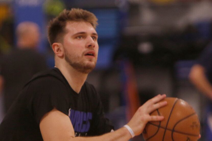 Luka Doncic sizes up a shot on his first day back to practice with teammates since sidelined...