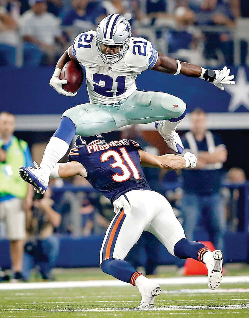Dallas Cowboys rookie running back Ezekiel Elliott leaped over Chicago Bears safety Chris...