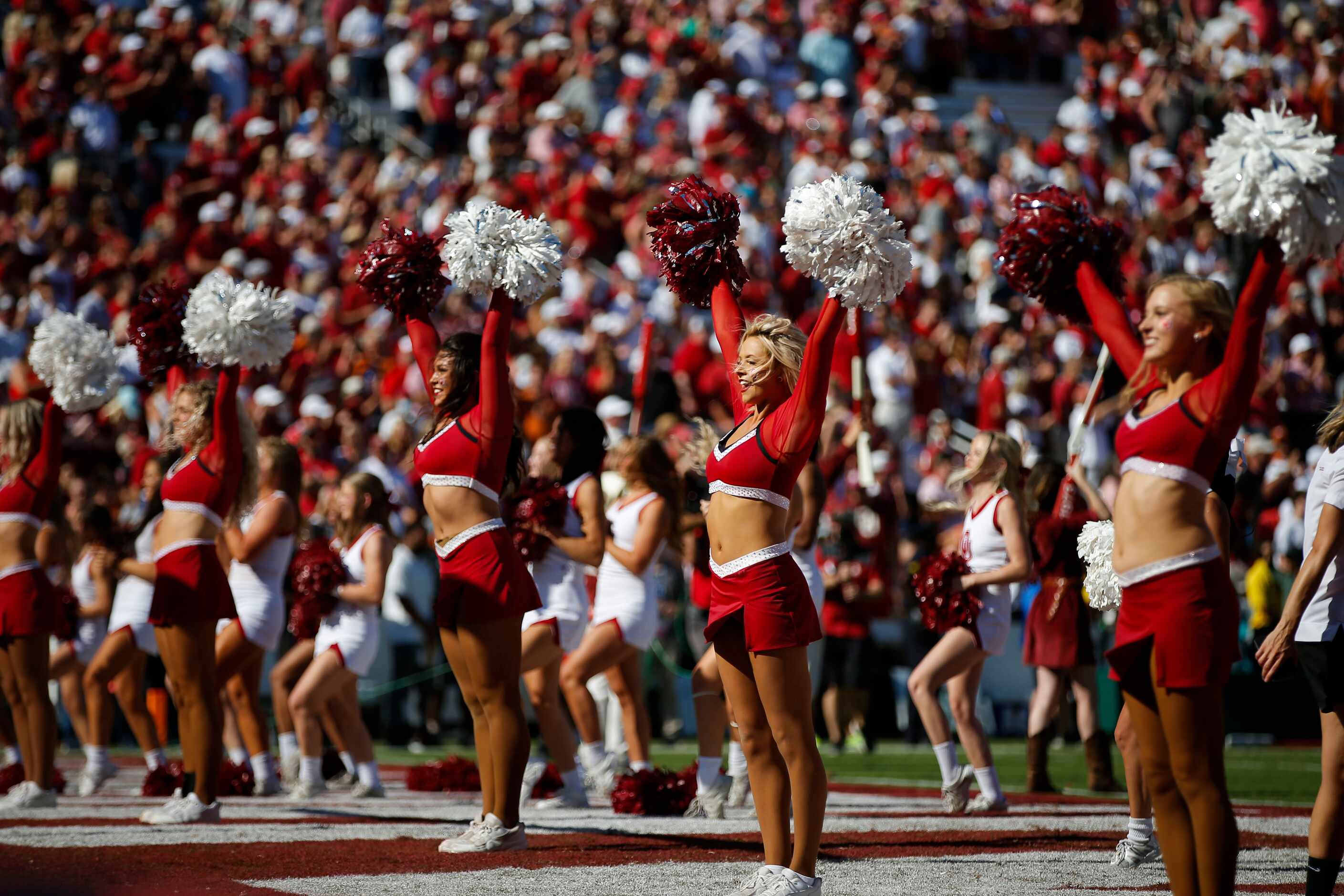 Oklahoma’s drill team leads school fans in cheering for their team during the first half of...