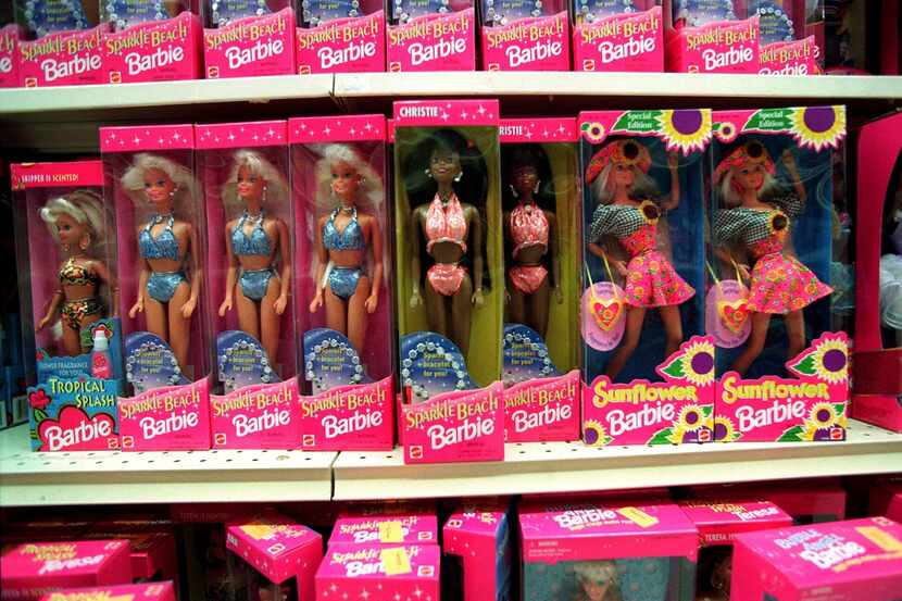 Barbie dolls line the shelves at a toy store in Torrance, Calif., on Dec. 14, 1995.