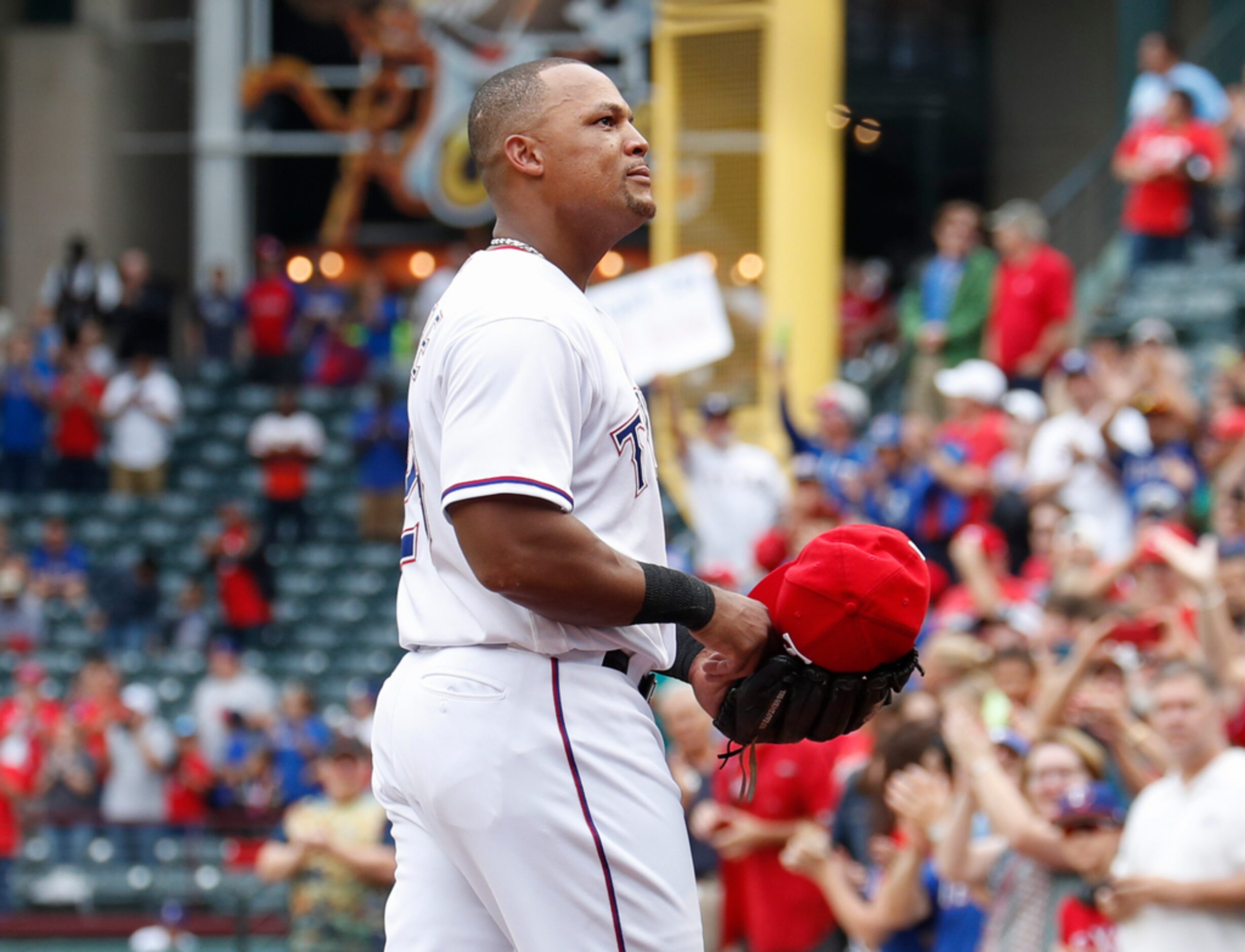 Texas Rangers' Adrian Beltre walks to the dugout after being relieved of his duties at third...