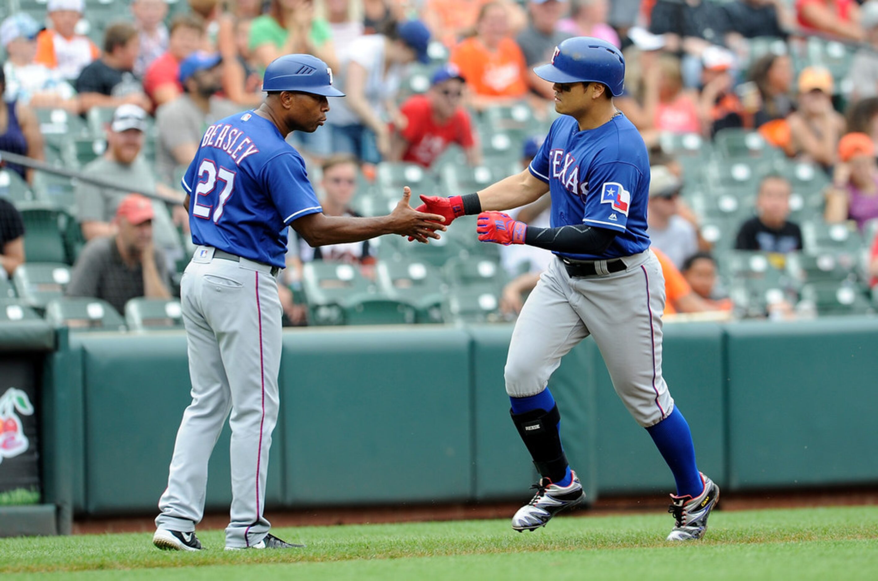 BALTIMORE, MD - JULY 15:  Shin-Soo Choo #17 of the Texas Rangers celebrates with third base...