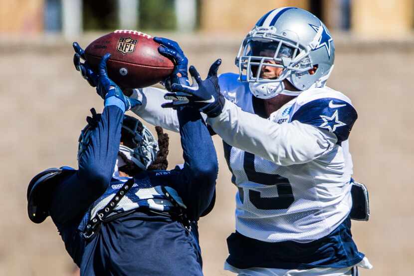 Dallas Cowboys cornerback Donovan Olumba (32) intercepts a pass intended for wide receiver...