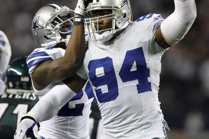 Cowboys CB Morris Claiborne (24) celebrates with DE DeMarcus Ware after Ware recovered a...
