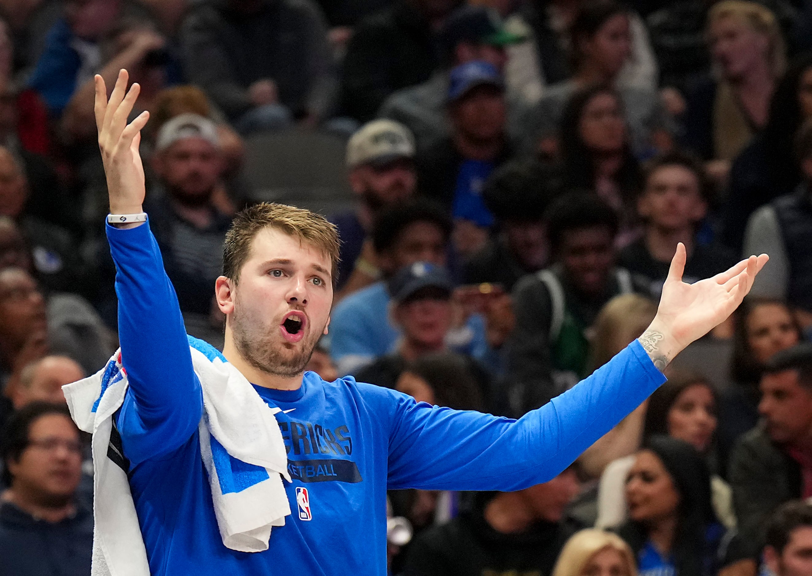 Dallas Mavericks guard Luka Doncic reacts on the bench during the second half of an NBA...