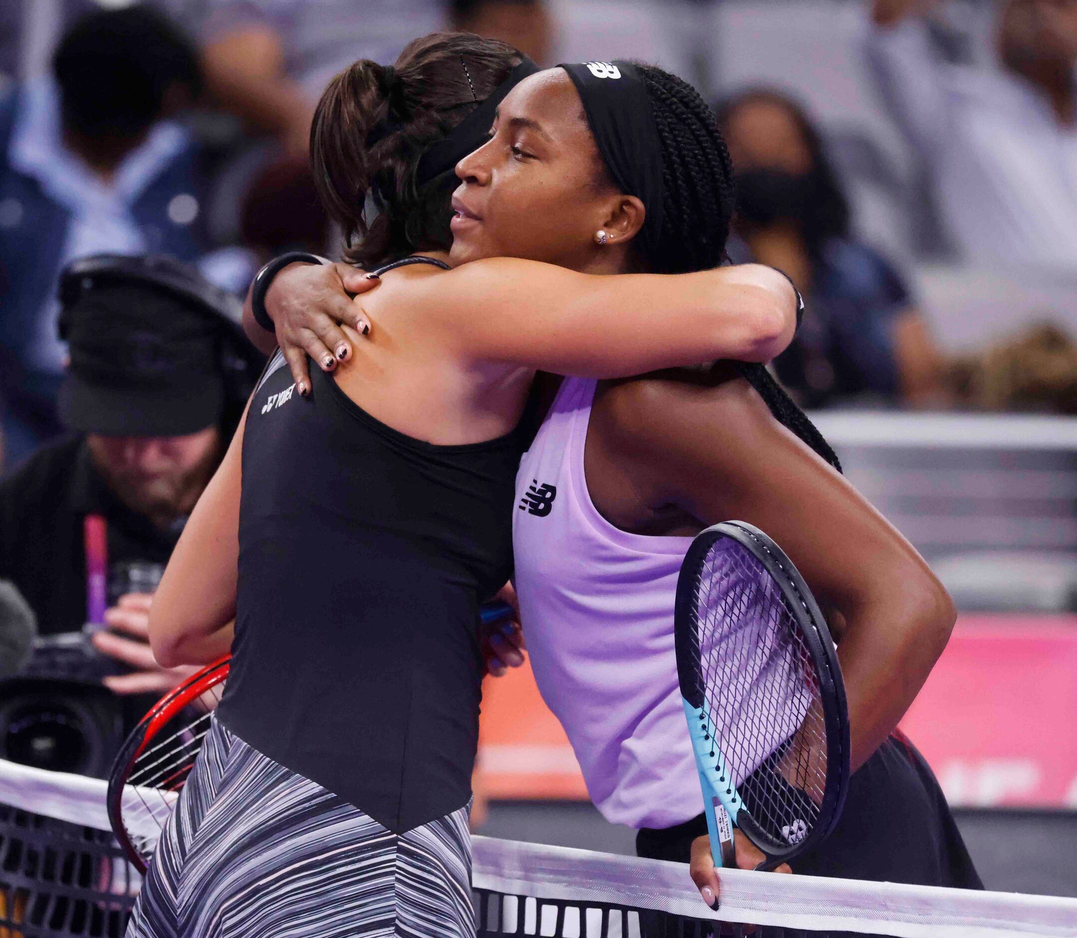 Coco Gauff of the USA, right, and Caroline Garcia of France embrace each other after their...
