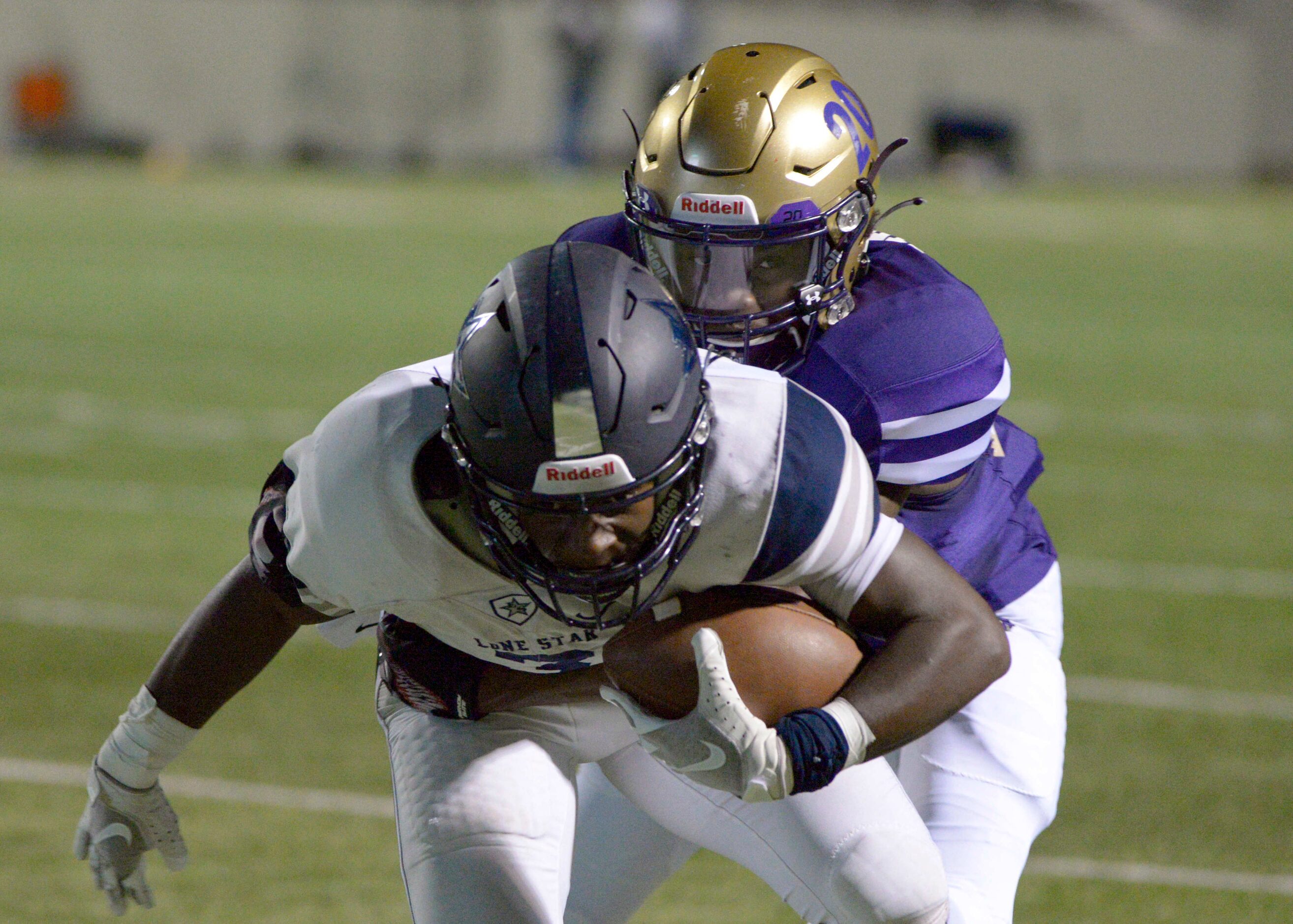 Denton’s Derrek Stringer (20) tackle’s Lone Star’s Tolu Sokoya (3) in the first quarter of a...