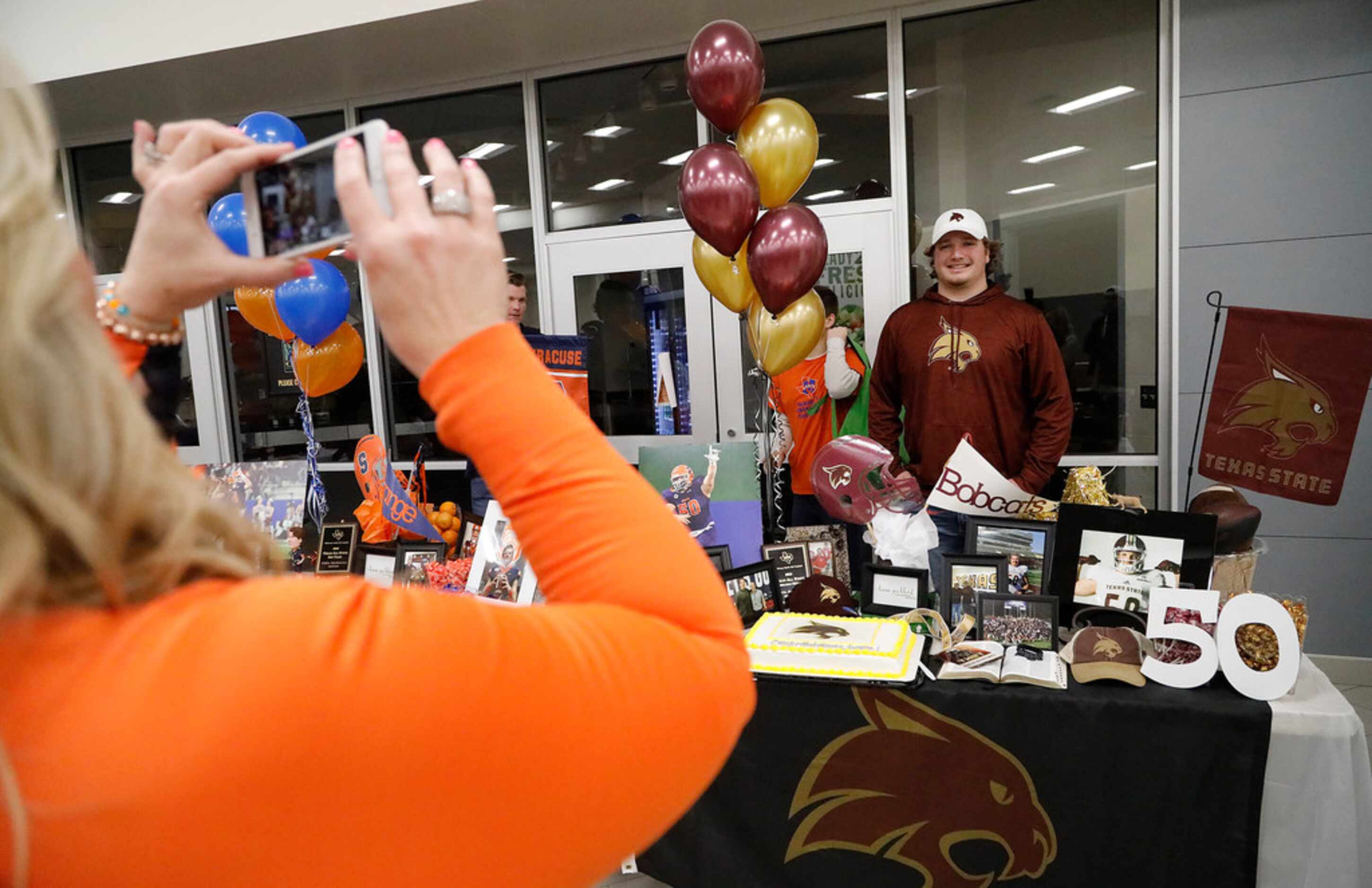 Austin Markiewicz has his picture made after signing with Texas State during the National...