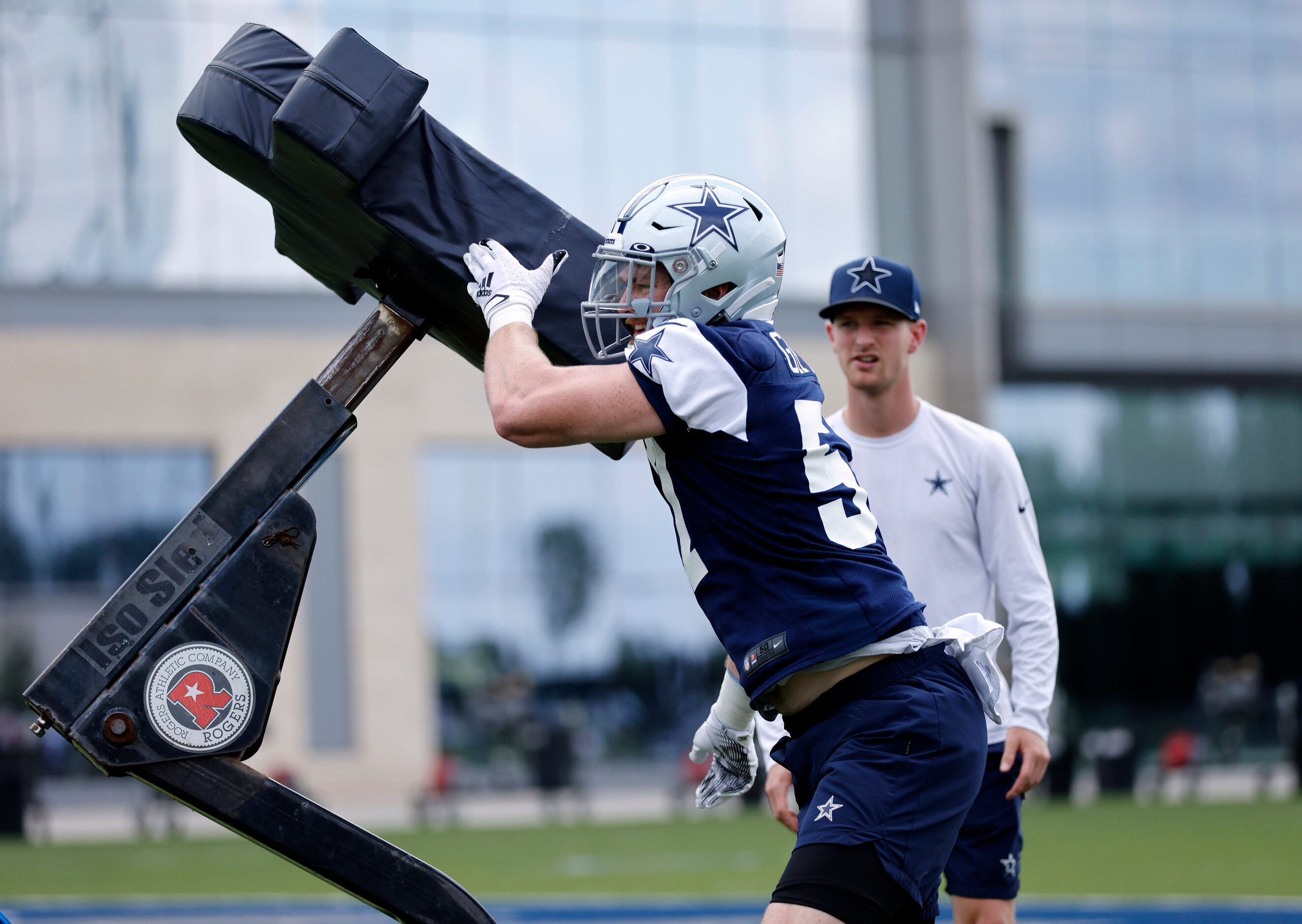 Dallas Cowboys linebacker Luke Gifford (57) pushes off a blocking dummy during training camp...