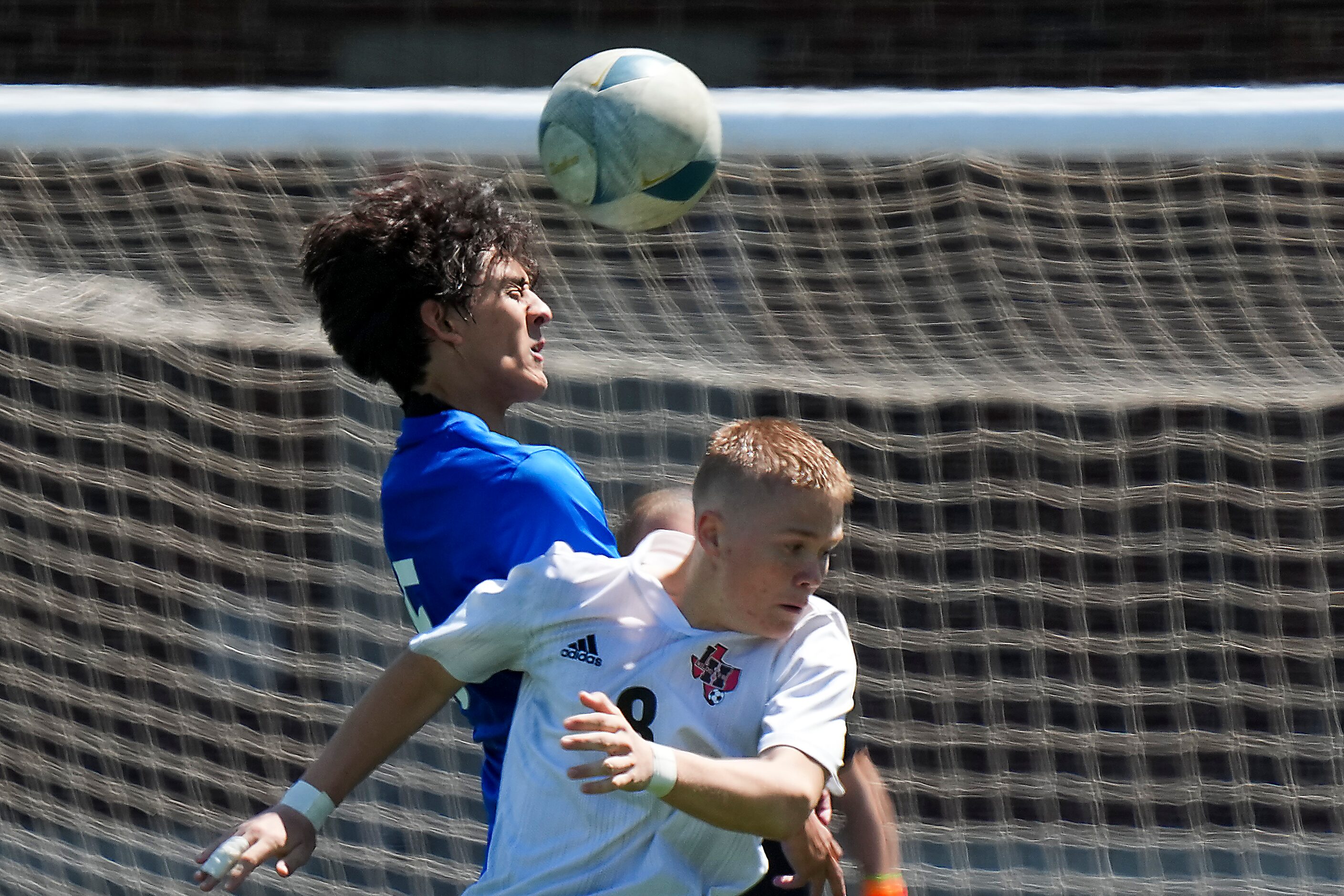 Allen defender Kyu Peterson (5) wins a header against Lake Highlands forward Evan Bernhard...