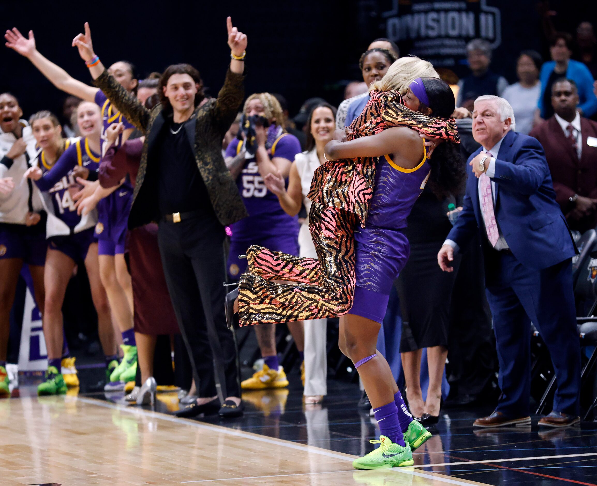 LSU Lady Tigers head coach Kim Mulkey leaps into the arms of her guard Flau'jae Johnson (4)...