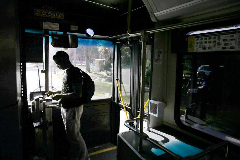 
Davonte Galbert boards a DART bus at Haverwood Lane and Pear Ridge Drive in Dallas on his...