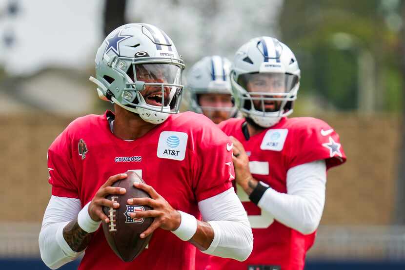 Dallas Cowboys quarterback Dak Prescott (4) participates in a drill with Will Grier (15) and...