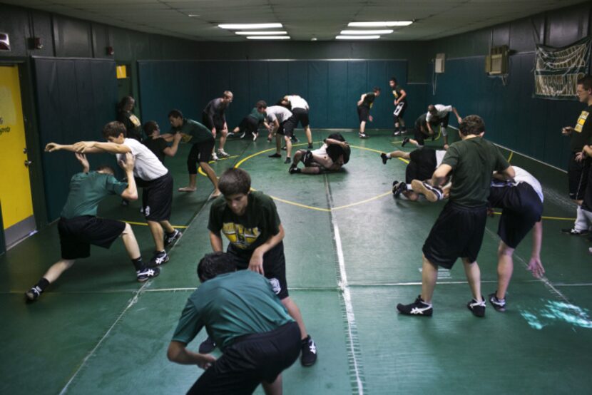 Packed into a double-wide trailer converted into a wrestling room, the Birdville High...