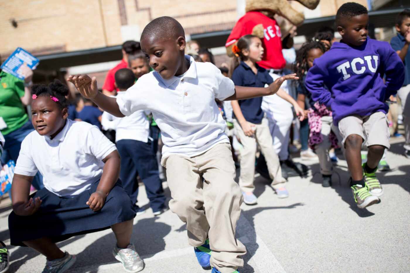 Deujerey Satchell (center), 7, showed off his dance moves during the kickoff of the training...