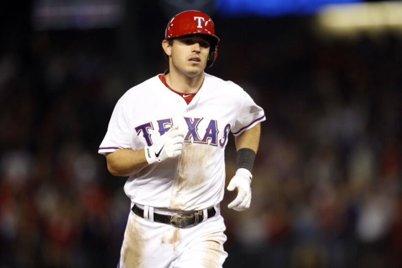 Texas Rangers second baseman Ian Kinsler (5) rounds the bases after hitting a three run home...