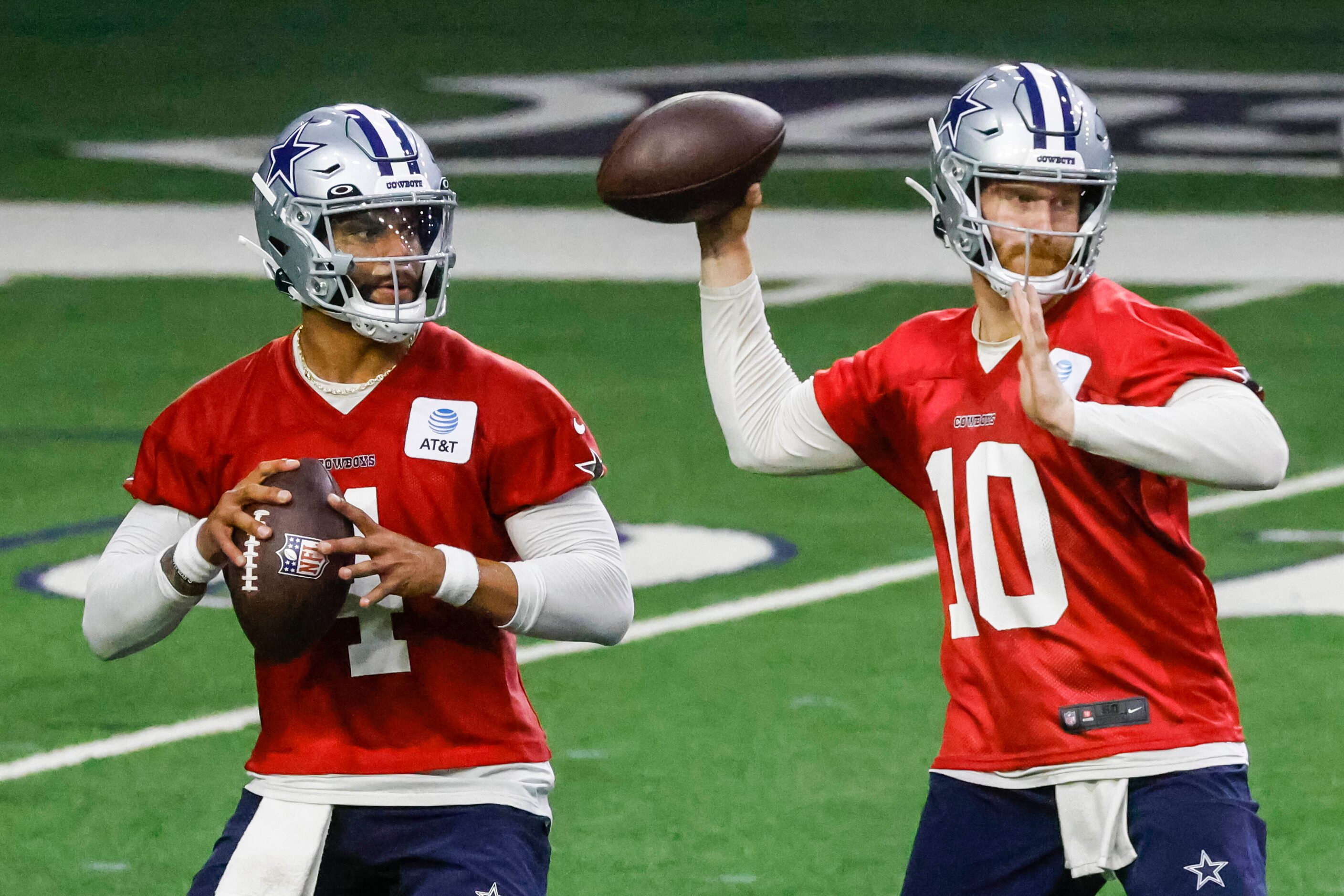 Dallas Cowboys quarterbacks Dak Prescott (left) and Cooper Rush throw the ball during OTA...