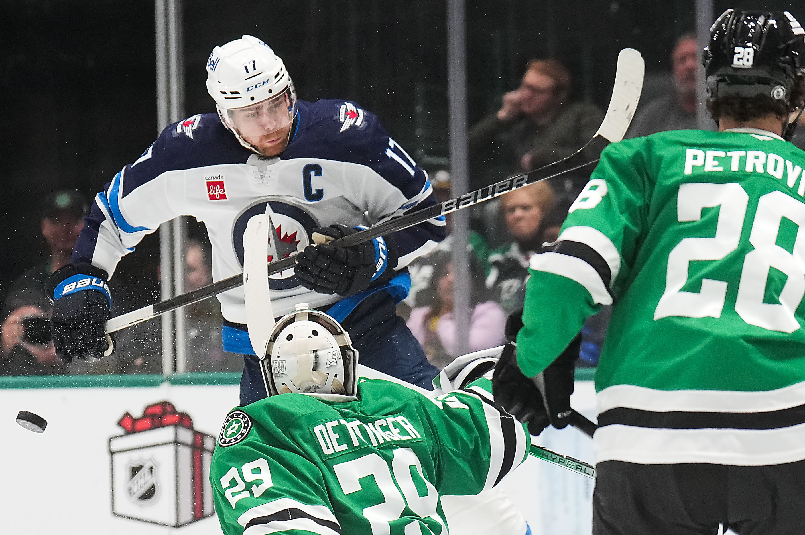 Winnipeg Jets center Adam Lowry (17) can’t get a stick on a rebound off a save by Dallas...