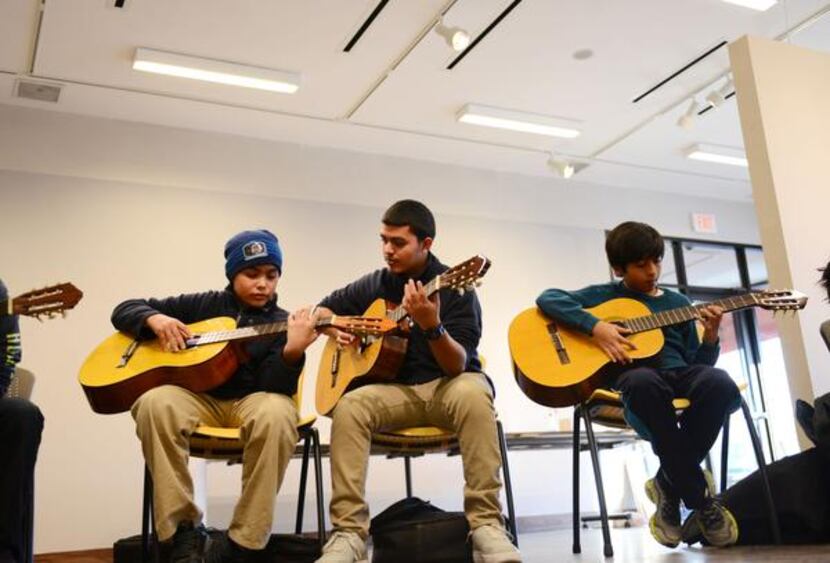 
Guitar students (from left) Joel Torres, 10, Jose Christopher Torres, 16, and Edgar...