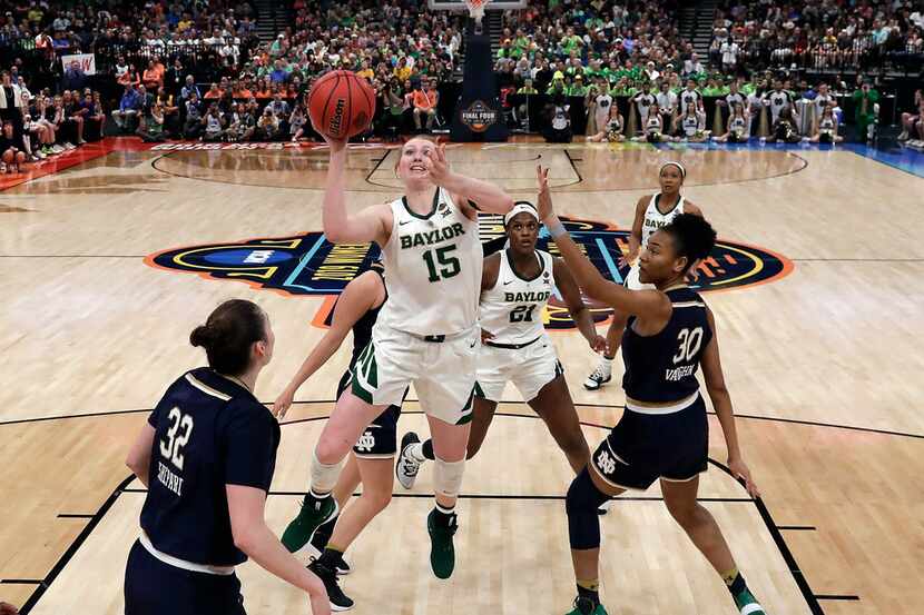 Baylor's Lauren Cox (15) goes up for a shot past Notre Dame's Mikayla Vaughn (30) and...