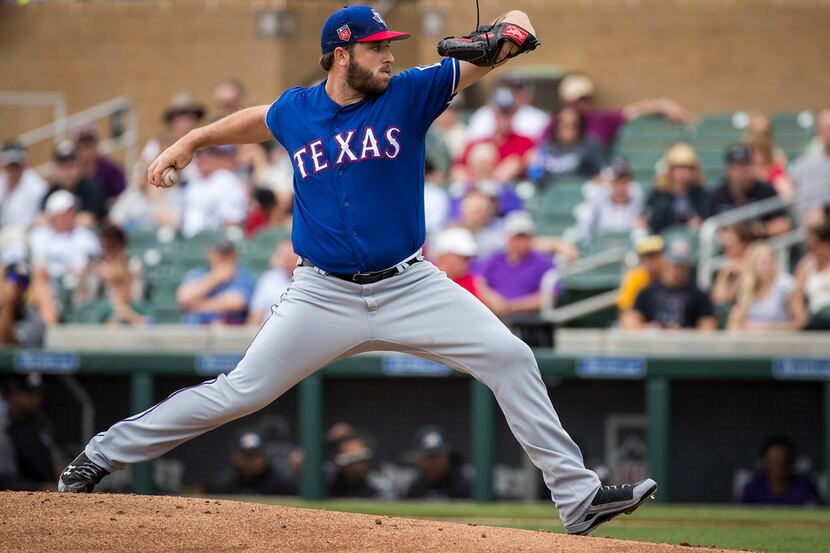Texas Rangers pitcher Clayton Blackburn pitches during the second inning of a spring...