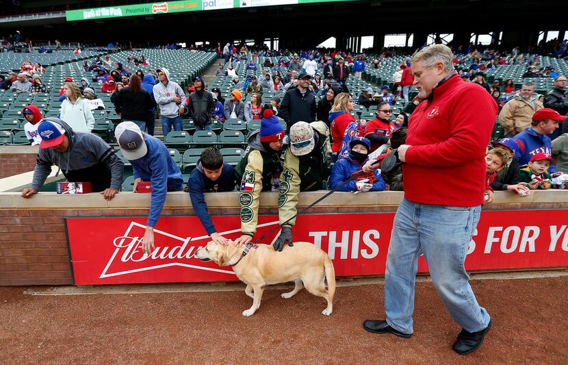 Rangers fan Bill Mahoney walks on the ground with his dog Delilah, 7, during the annual Bark...